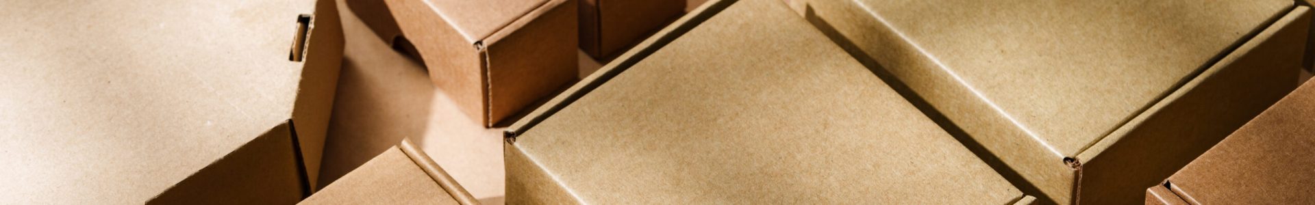 Multiple cardboard boxes arranged on a surface for packaging and shipping in a warehouse setting close up